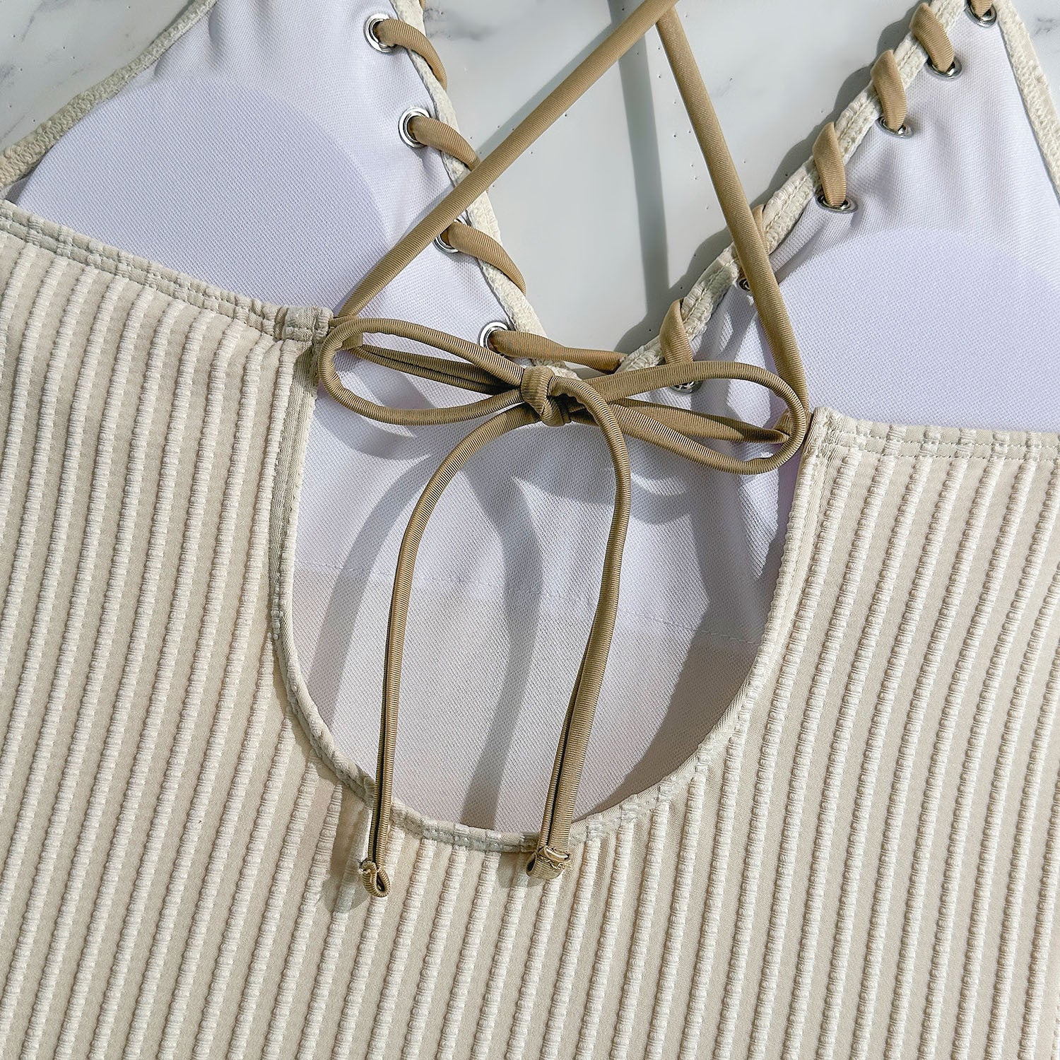 Backless cutout swimsuit with rope‑tie straps
