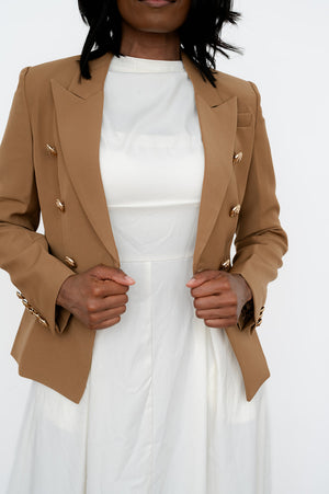 Women’s office blazer with double‑breasted front and lion buckle