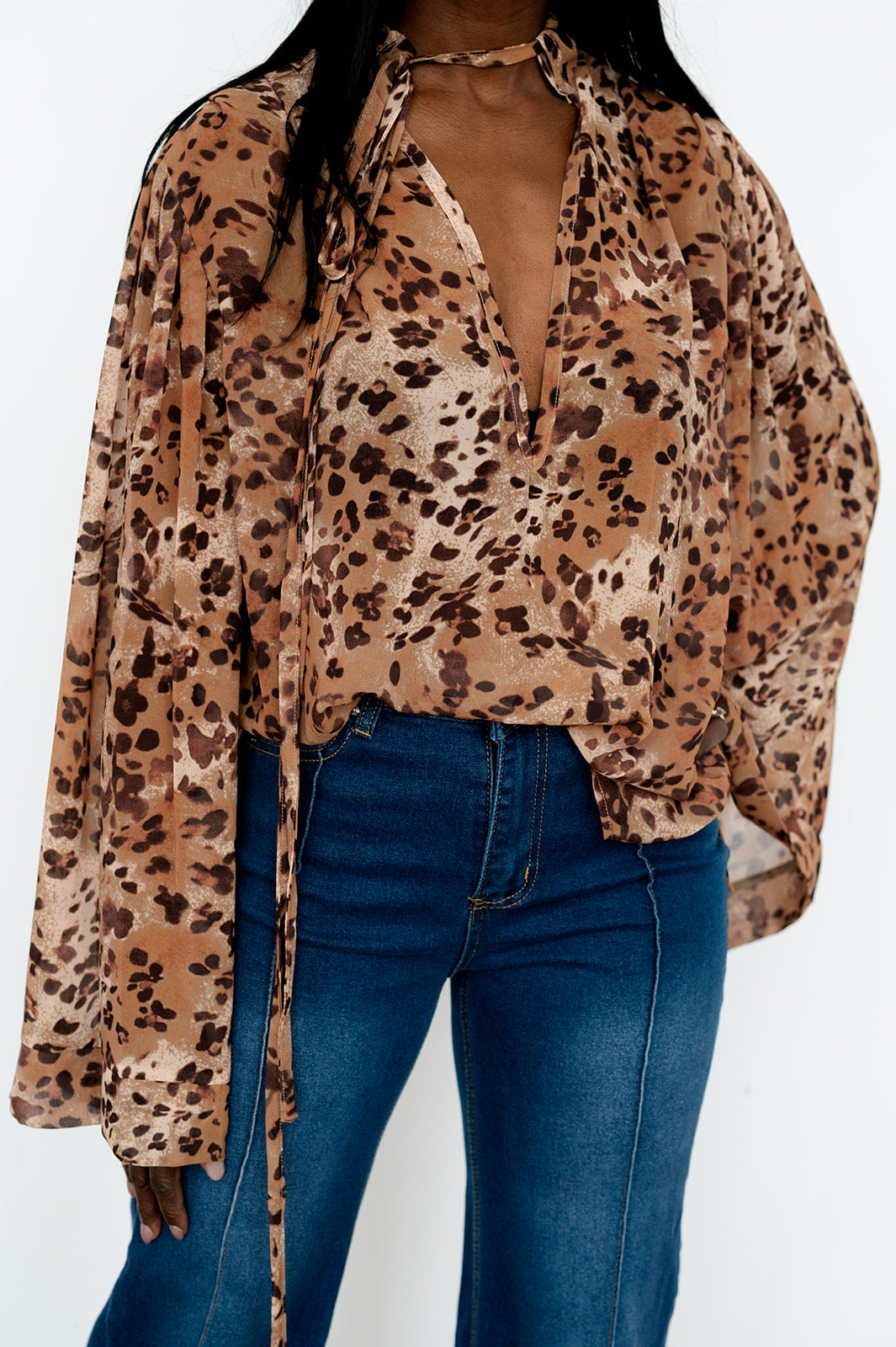 Animal‑print long‑sleeve blouse with cutout detail
